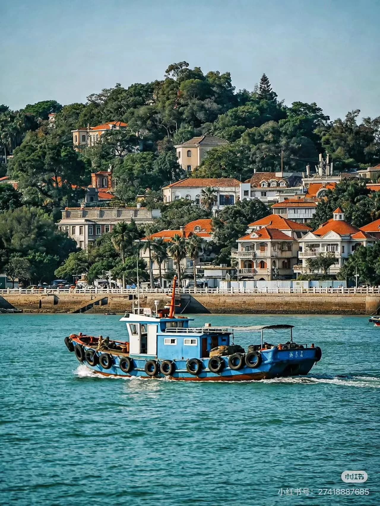 Colonial-era mansions and tropical greenery lining a narrow pedestrian lane on Gulangyu Island