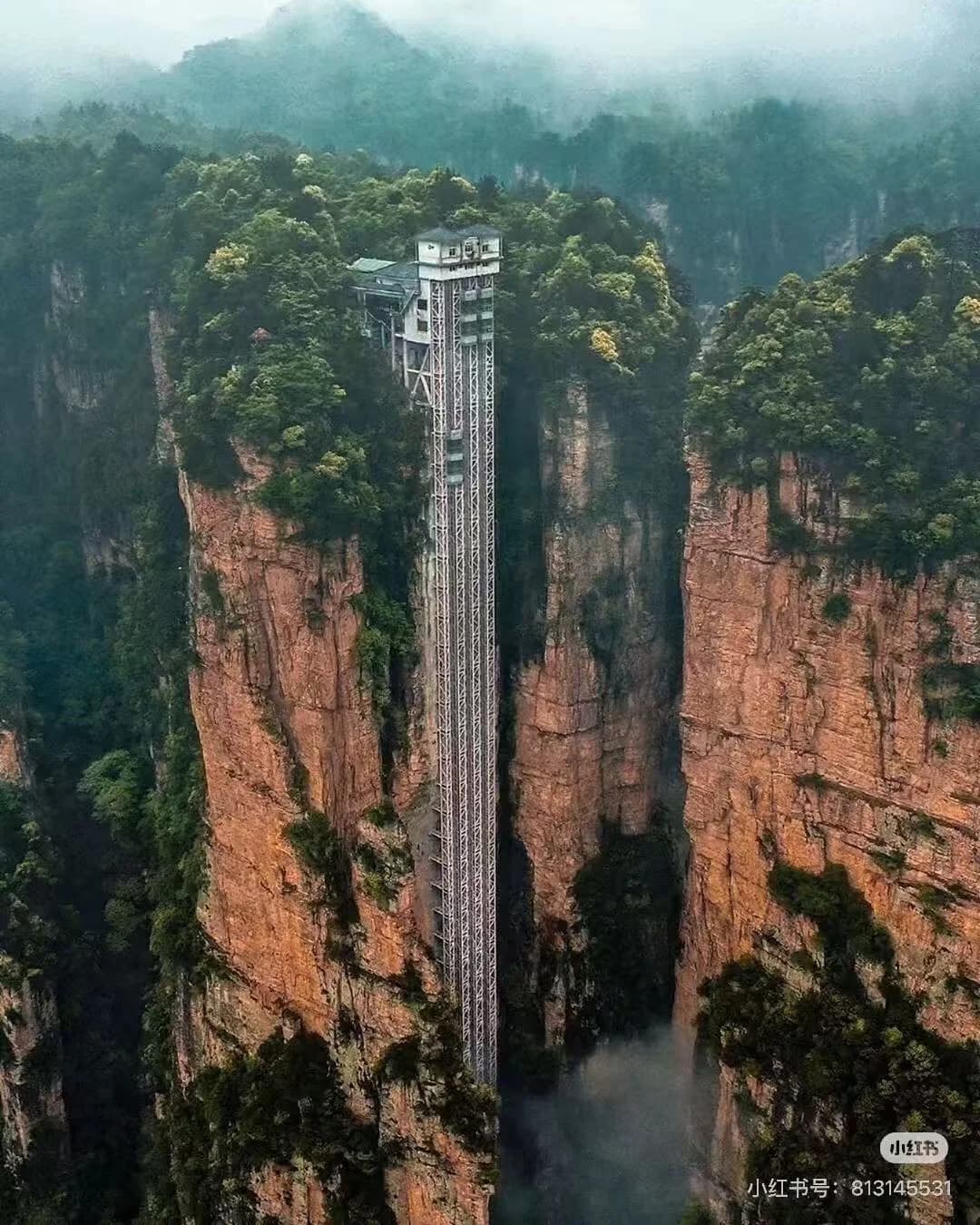 Wulingyuan scenic area viewed from Yuanjiajie platform, sandstone pillars emerging through morning mist