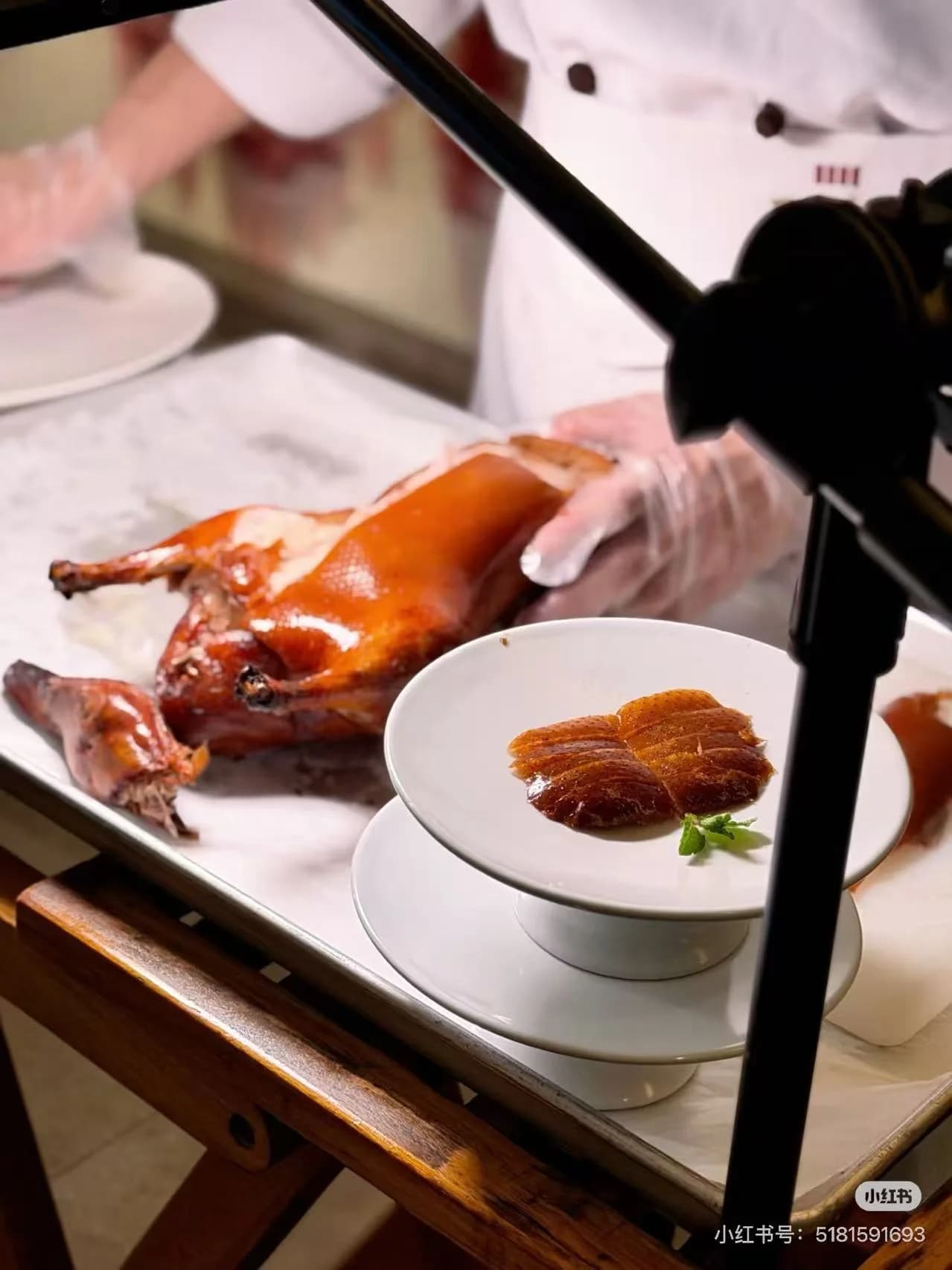 Chef slicing Peking duck tableside in a Beijing restaurant