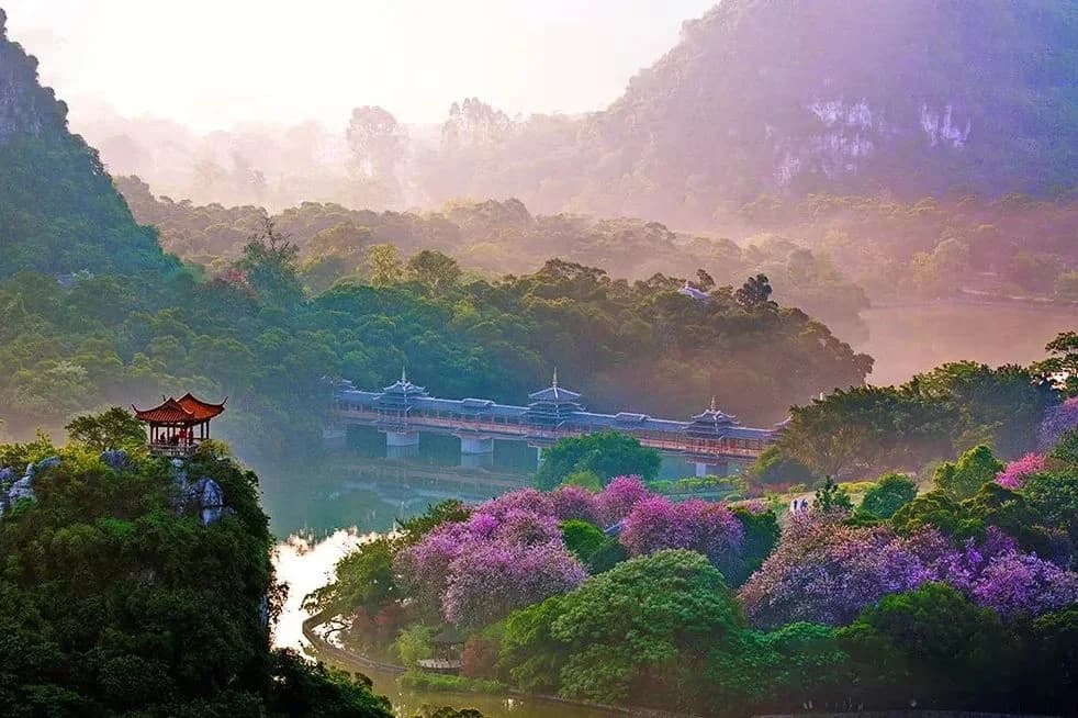 A Chinese bullet train runs between karst peaks and river valleys, with the landscapes of Guangxi and Yunnan outside the window.