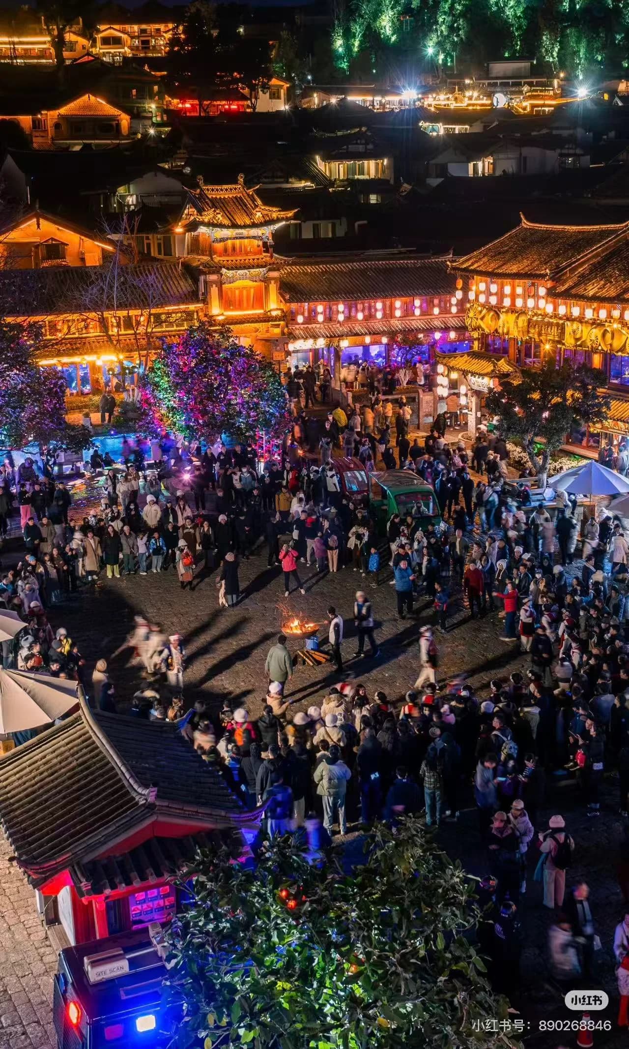 Stone paths of Lijiang Old Town winding between traditional wooden buildings at dusk