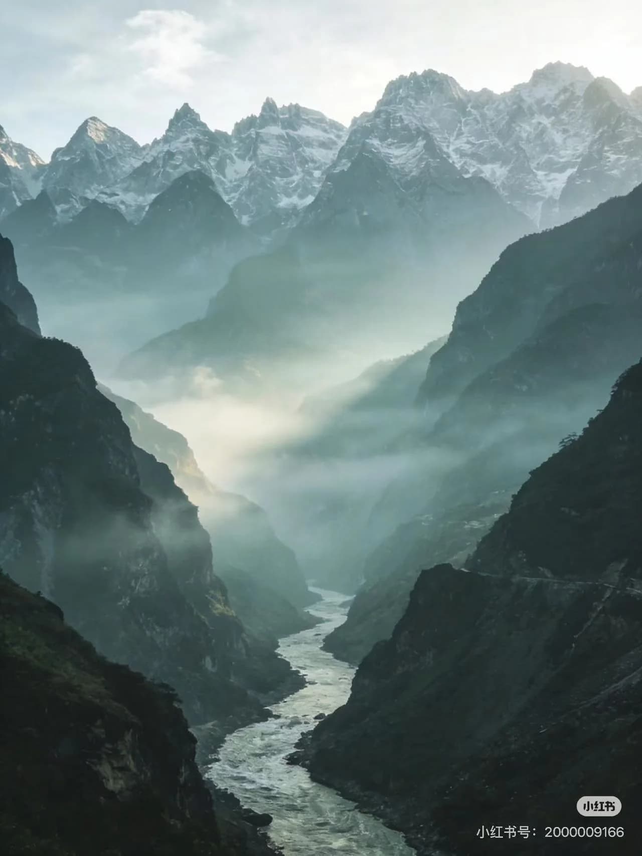 The narrow Tiger Leaping Gorge with the Jinsha River rushing between steep cliffs under clear sky